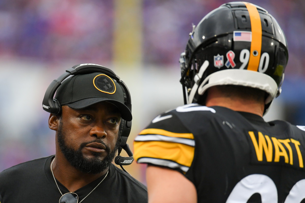 Pittsburgh Steelers head coach Mike Tomlin talks with outside linebacker T.J. Watt (90) against the Buffalo Bills during the second half at Highmark Stadium.