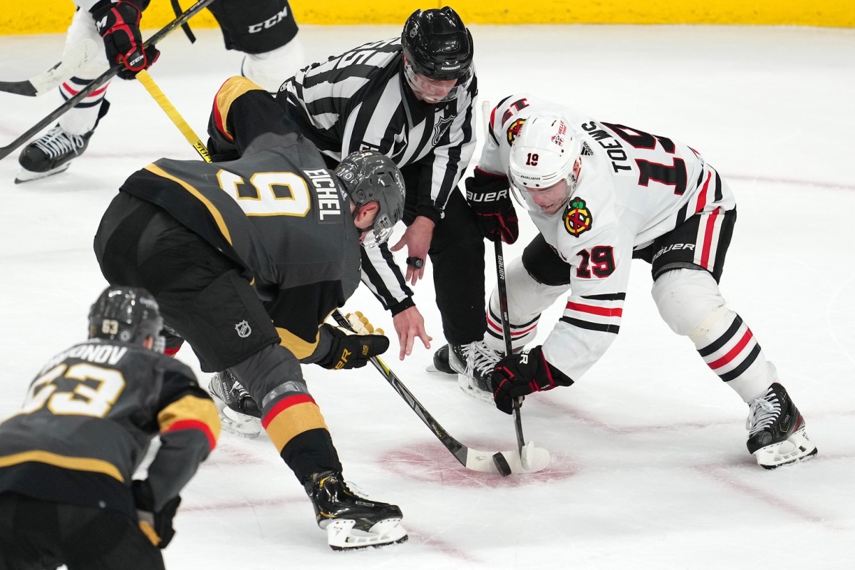 Vegas Golden Knights center Jack Eichel (9) wins a face off against Chicago Blackhawks center Jonathan Toews (19) during the third period at T-Mobile Arena. 
