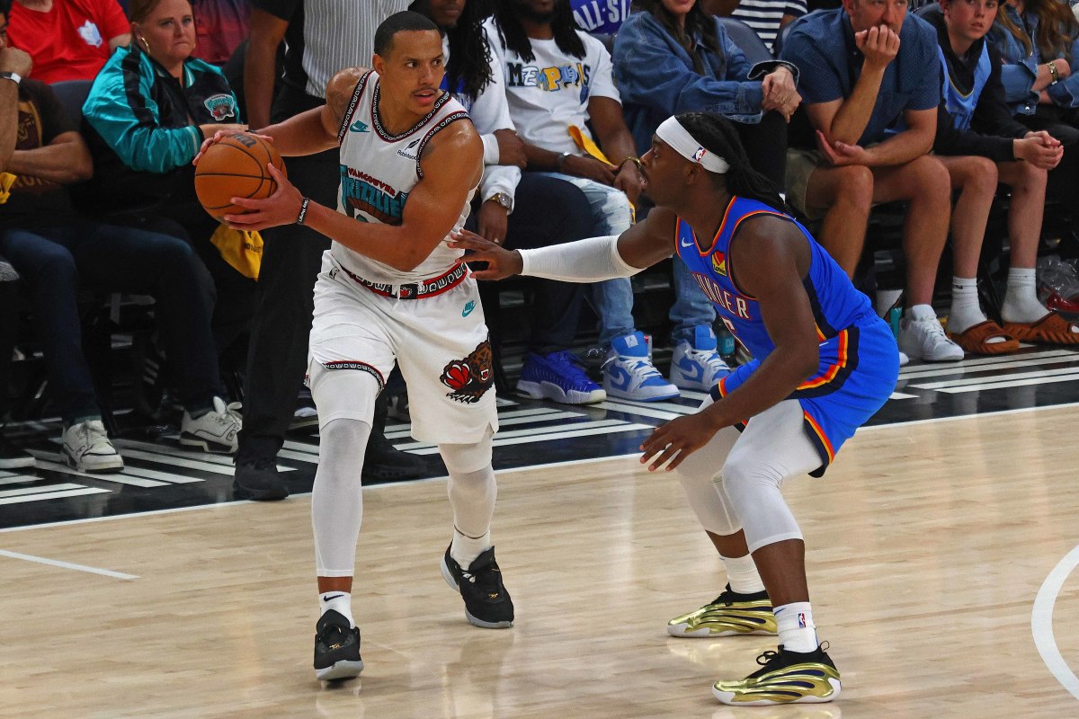 Desmond Bane handles the ball as Oklahoma City Thunder guard Luguentz Dort defends.