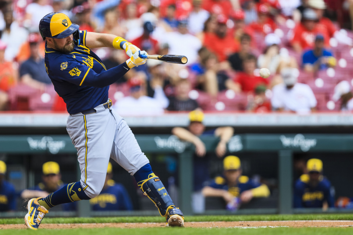 Milwaukee Brewers first baseman Rhys Hoskins (12) hits a single in the fourth inning against the Cincinnati Reds at Great American Ball Park.