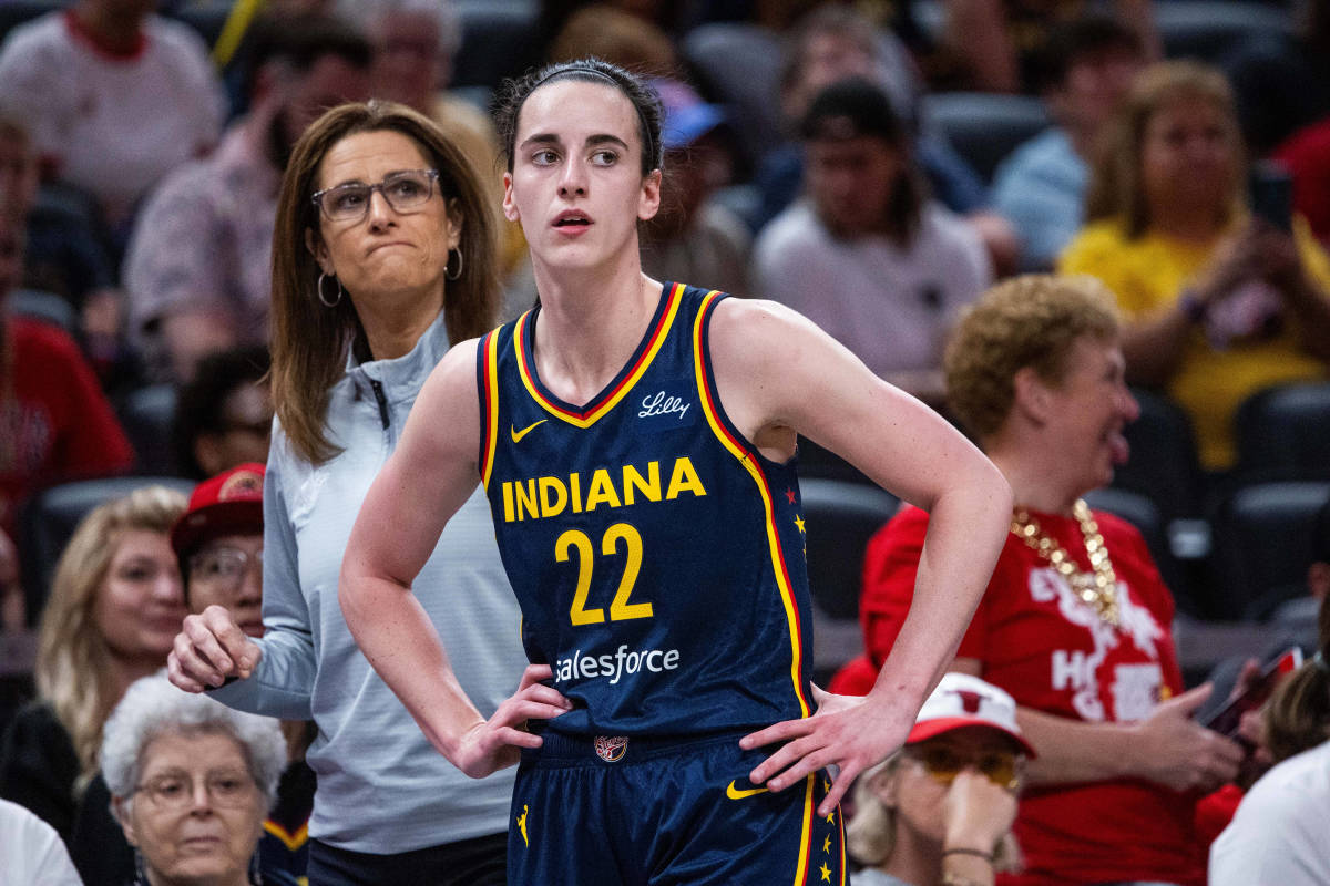 Indiana Fever guard Caitlin Clark (22) and head coach Stephanie White look on during a game.