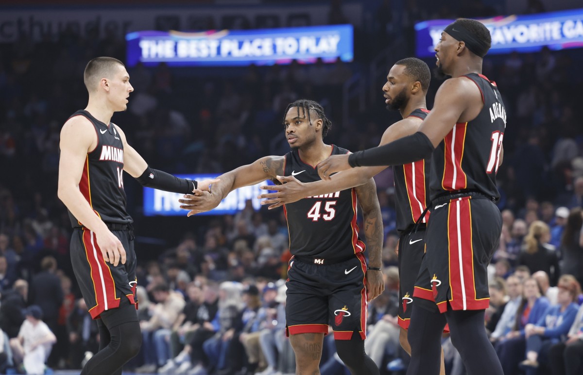 Miami Heat guard Tyler Herro (14), guard Davion Mitchell (45), forward Andrew Wiggins (22) and center Bam Adebayo (13) high five after a play against the Oklahoma City Thunder during the first quarter...