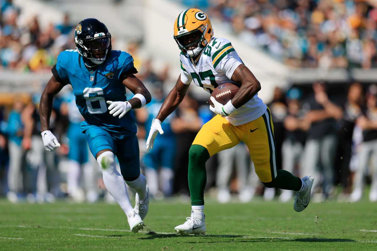 Green Bay Packers wide receiver Romeo Doubs (87) rushes for yards against Jacksonville Jaguars safety Darnell Savage (6).