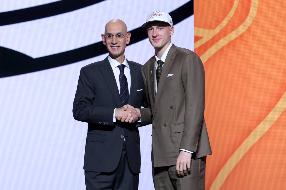 Kasparas Jakucionis stands with NBA commissioner Adam Silver after being selected as the 20th pick by the Miami Heat.