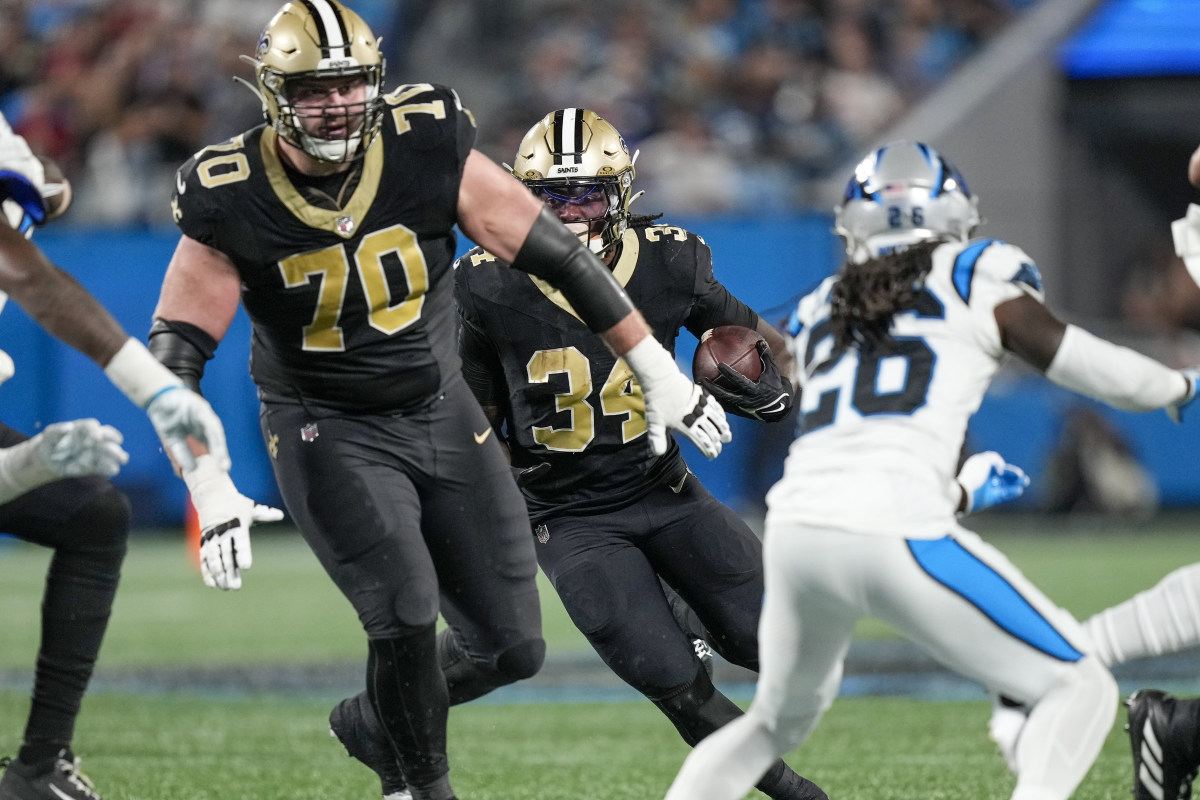 Sep 18, 2023; New Orleans Saints running back Tony Jones Jr. (34) follows a block by offensive tackle Trevor Penning (70) against the Carolina Panthers. Mandatory Credit: Jim Dedmon-Imagn Images