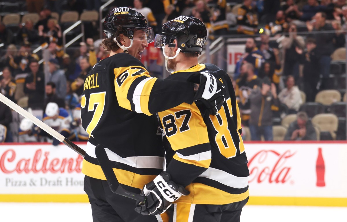 Pittsburgh Penguins right wing Rickard Rakell (67) and center Sidney Crosby (87) celebrate a goal by Rakell against the St. Louis Blues during the third period at PPG Paints Arena. 