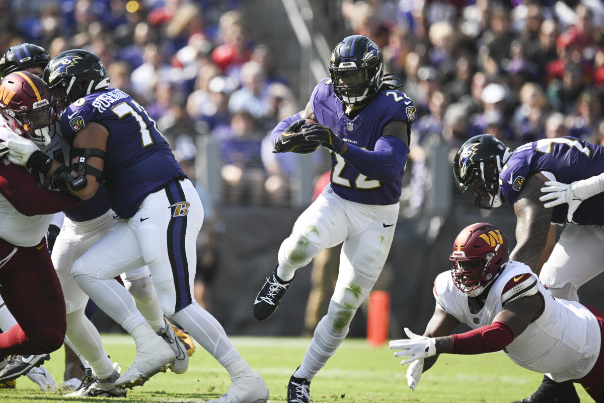 Oct 13, 2024; Baltimore, Maryland, USA; Baltimore Ravens running back Derrick Henry (22) rushes through the hole during the first half against the Washington Commanders at M&T Bank Stadium.