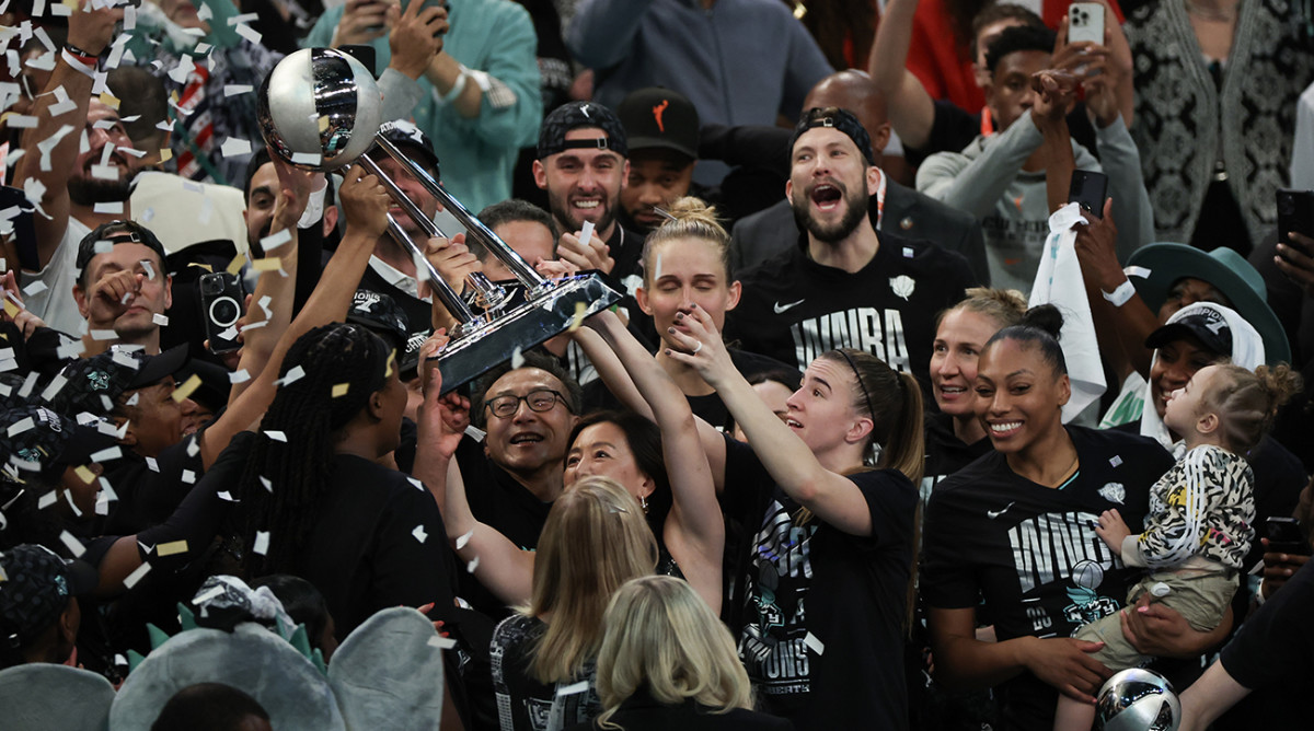 New York Liberty guard Sabrina Ionescu and team owner Clara Wu Tsai hoist the WNBA championship trophy after defeating the Minnesota Lynx in Game 5 of the WNBA Finals at Barclays Center on Oct. 20, 2024.