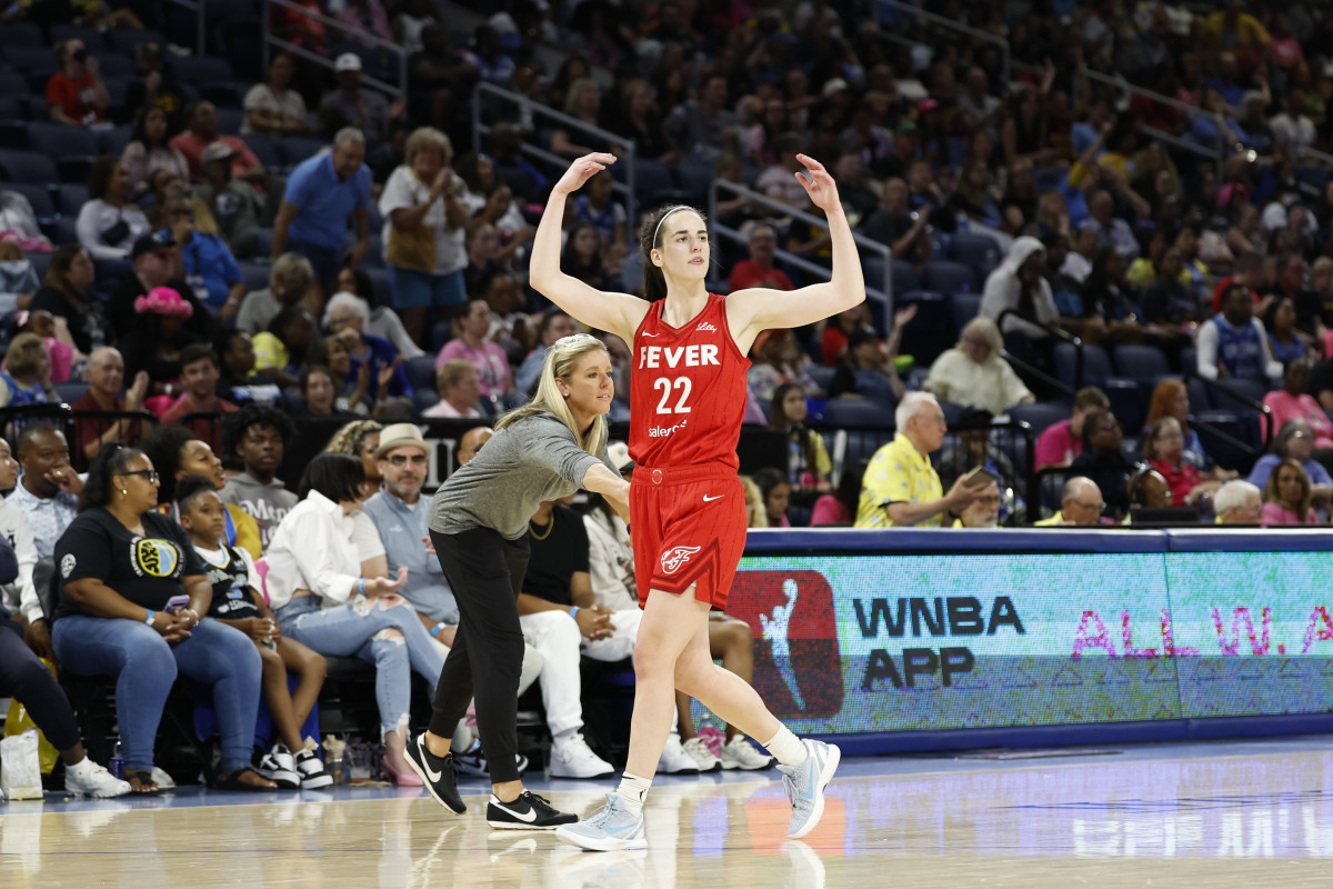 Fever star Caitlin Clark gestures to the crowd during a game against the Sky.