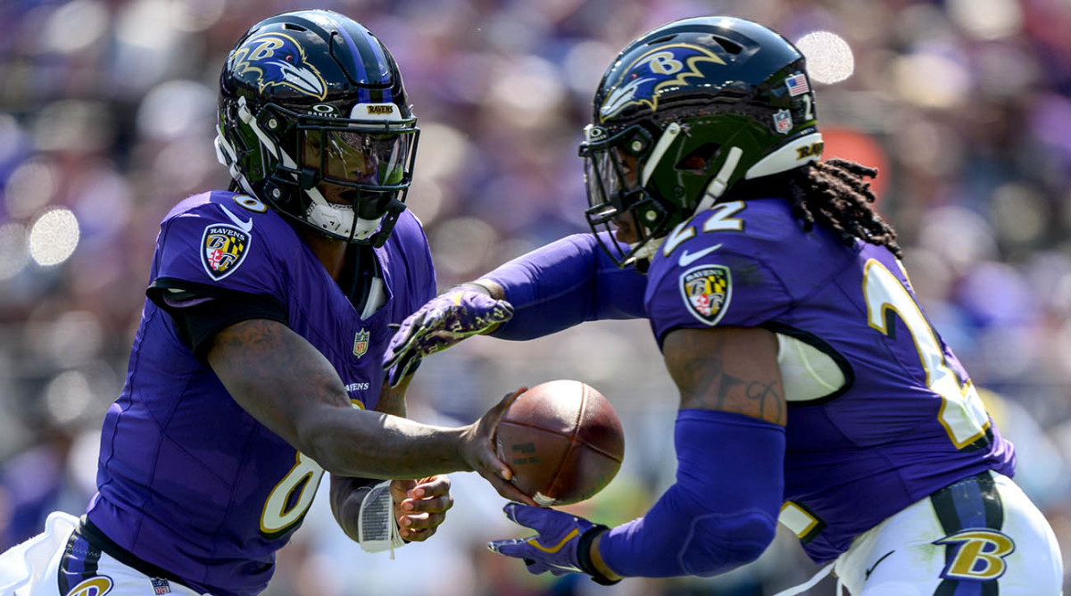 Ravens quarterback Lamar Jackson hands the ball off to Derrick Henry during a Week 2 game against the Raiders.