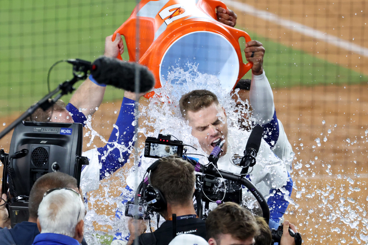 Oct 25, 2024; Los Angeles, California, USA; Los Angeles Dodgers first baseman Freddie Freeman (5) celebrates with teammates after hitting a grand slam home run in the tenth inning against the New York Yankees during game one of the 2024 MLB World Series at Dodger Stadium. Mandatory Credit: Kiyoshi Mio-Imagn Images