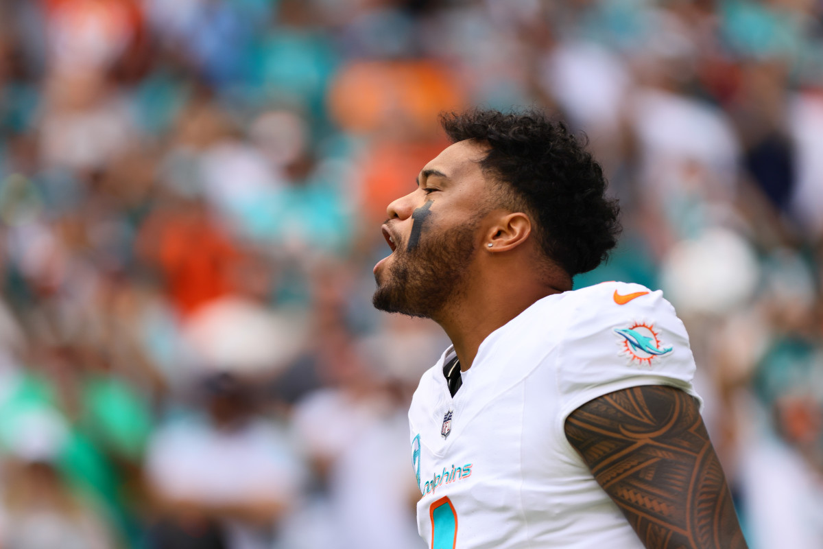 Oct 27, 2024; Miami Gardens, Florida, USA; Miami Dolphins quarterback Tua Tagovailoa (1) reacts as he takes on the field before the game against the Arizona Cardinals at Hard Rock Stadium.