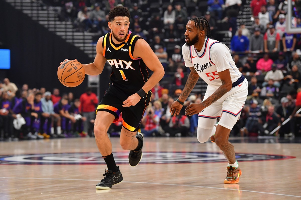 Phoenix Suns guard Devin Booker pushes the ball upcourt as Los Angeles Clippers forward Derrick Jones Jr. defends at Intuit Dome on Oct. 31, 2024.