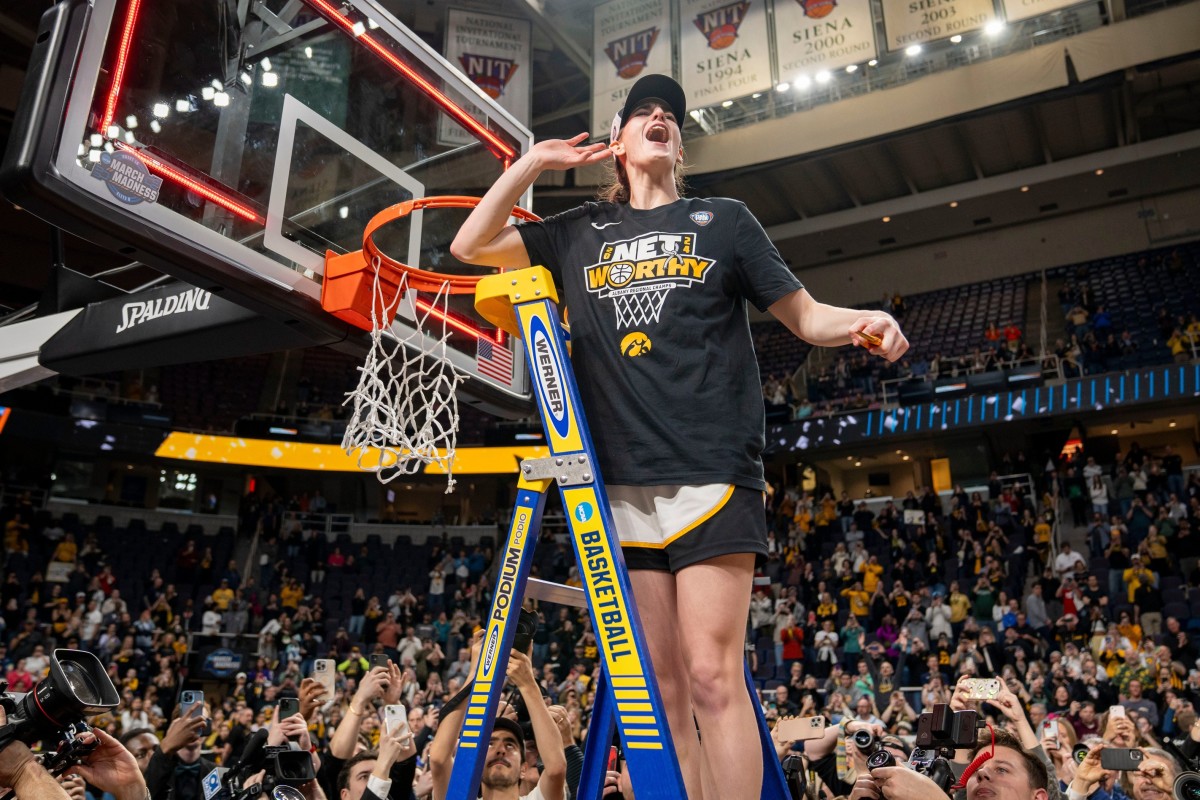 Iowa Hawkeyes guard Caitlin Clark cuts down the net after her team beat the LSU Tigers in the Elite Eight round of the NCAA Tournament on April 1, 2024, in Albany, N.Y.