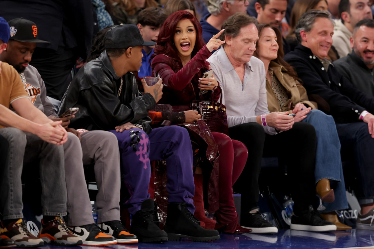 American rapper Cardi B (center) talks to rapper A Boogie Wit da Hoodie (left) during the third quarter between the New York Knicks and the Milwaukee Bucks at Madison Square Garden. Mandatory Credit: Brad Penner-Imagn Images