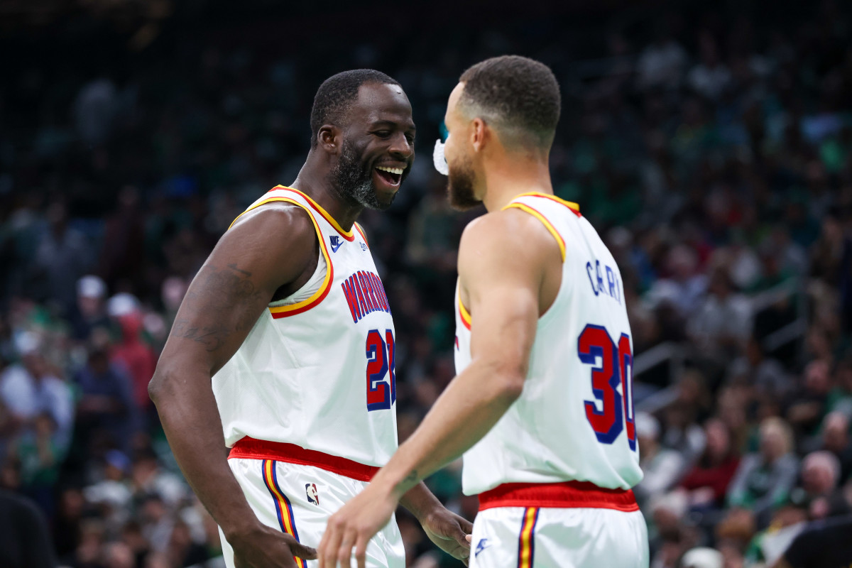 Golden State Warriors forward Draymond Green celebrates with guard Stephen Curry.