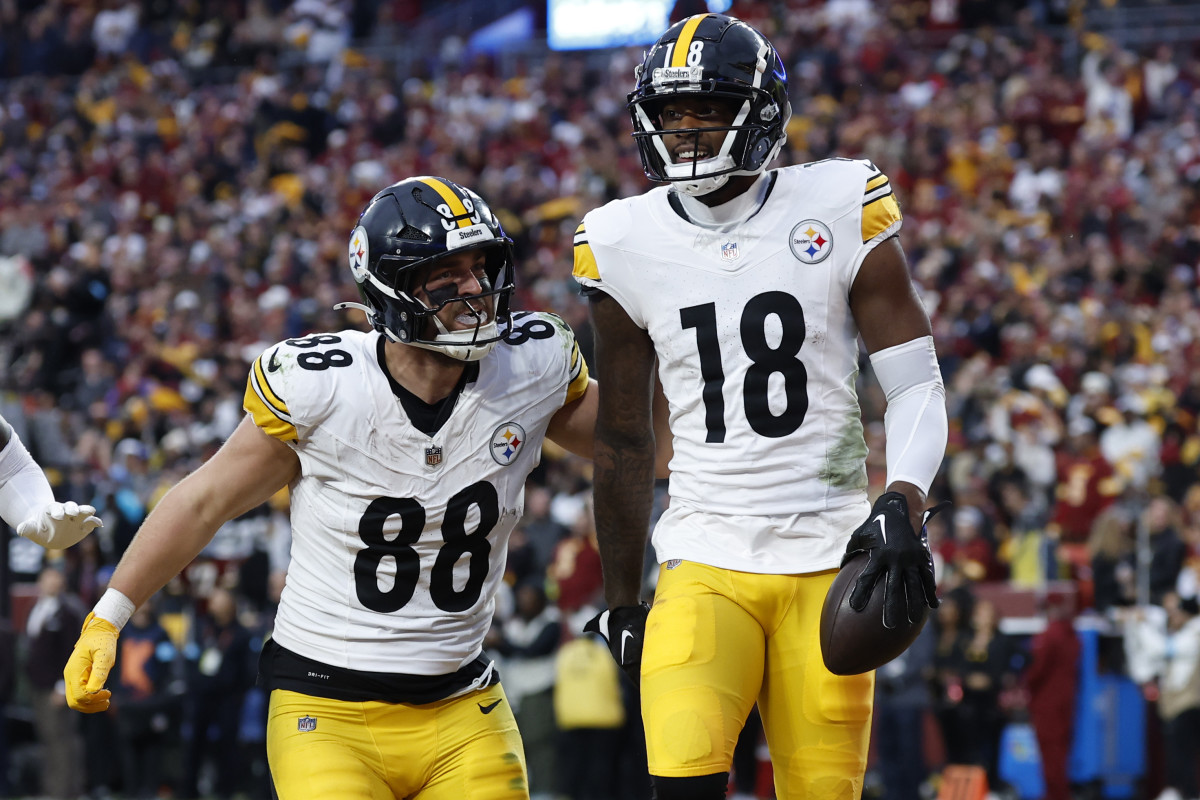 Pittsburgh Steelers wide receiver Mike Williams (18) celebrates with Steelers tight end Pat Freiermuth (88) after catching a touchdown pass against the Washington Commanders late in the second half at Northwest Stadium.