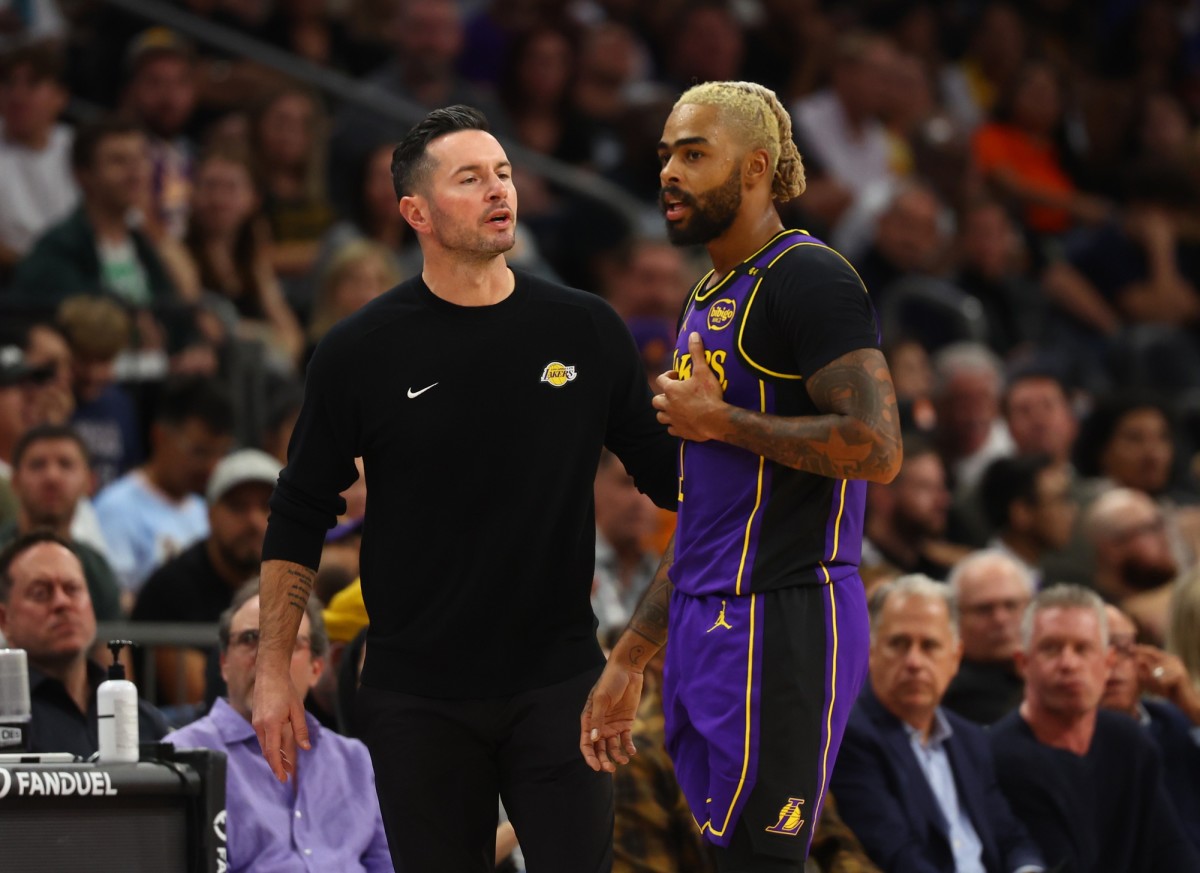 Los Angeles Lakers coach JJ Redick speaks with guard D’Angelo Russell during their game against against the Phoenix Suns at Footprint Center on Oct. 28, 2024.