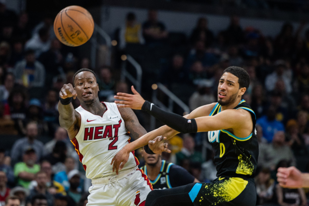 Apr 7, 2024; Indianapolis, Indiana, USA; Miami Heat guard Terry Rozier (2) passes the ball while Indiana Pacers guard Tyrese Haliburton (0) defends in the second half at Gainbridge Fieldhouse. Mandatory Credit: Trevor Ruszkowski-Imagn Images