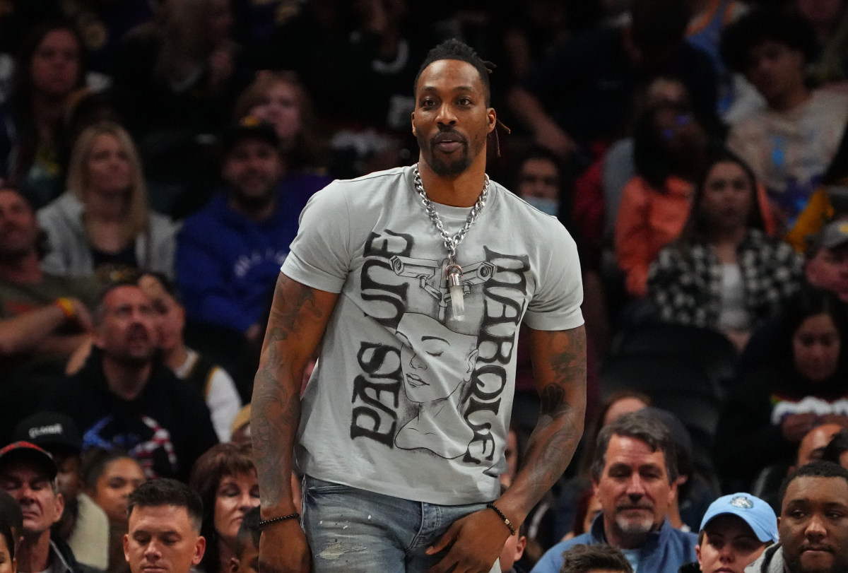 Former NBA center Dwight Howard watches a game at Ball Arena.