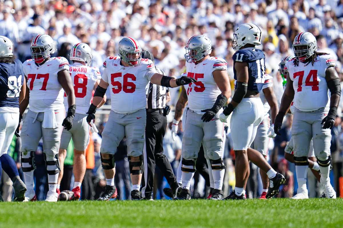 Ohio State Buckeyes offensive linemen, from left, Tegra Tshabola (77), Seth McLaughlin (56), Carson Hinzman (75) and Donovan Jackson (74) line up