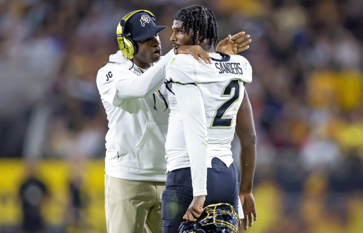 Colorado Buffaloes head coach Deion Sanders with son and quarterback Shedeur Sanders (2) against the Arizona State Sun Devils at Mountain America Stadium.