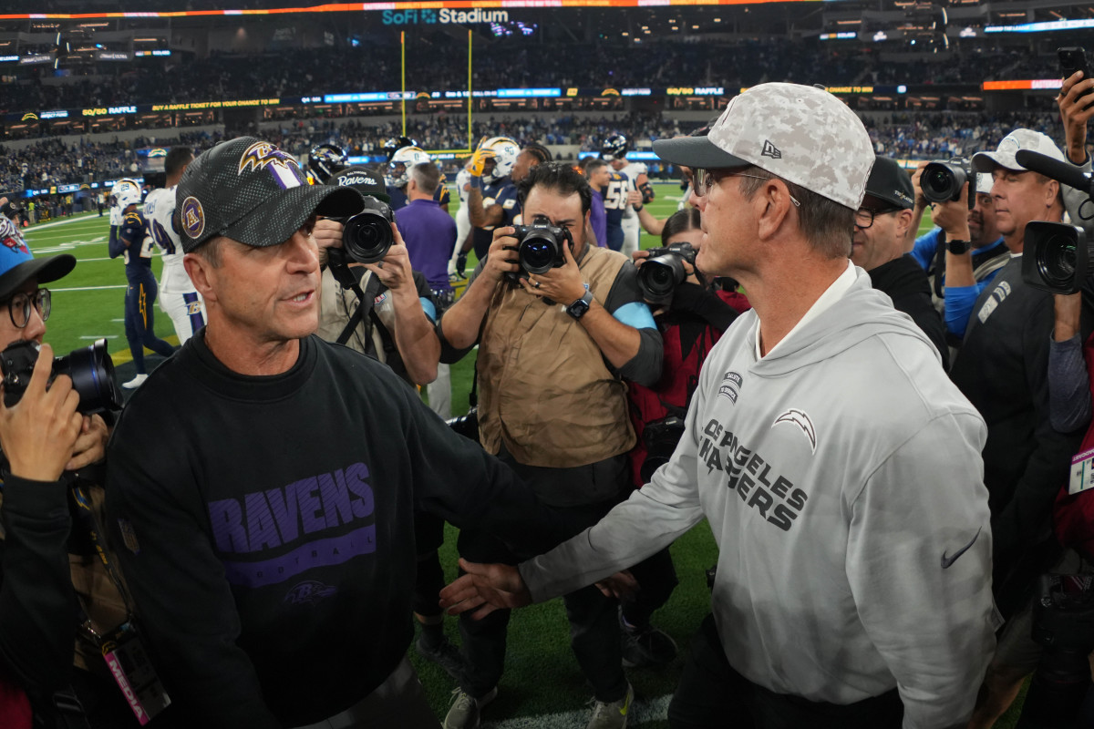 Baltimore Ravens coach John Harbaugh shakes hands with brother and Los Angeles Chargers coach Jim Harbaugh