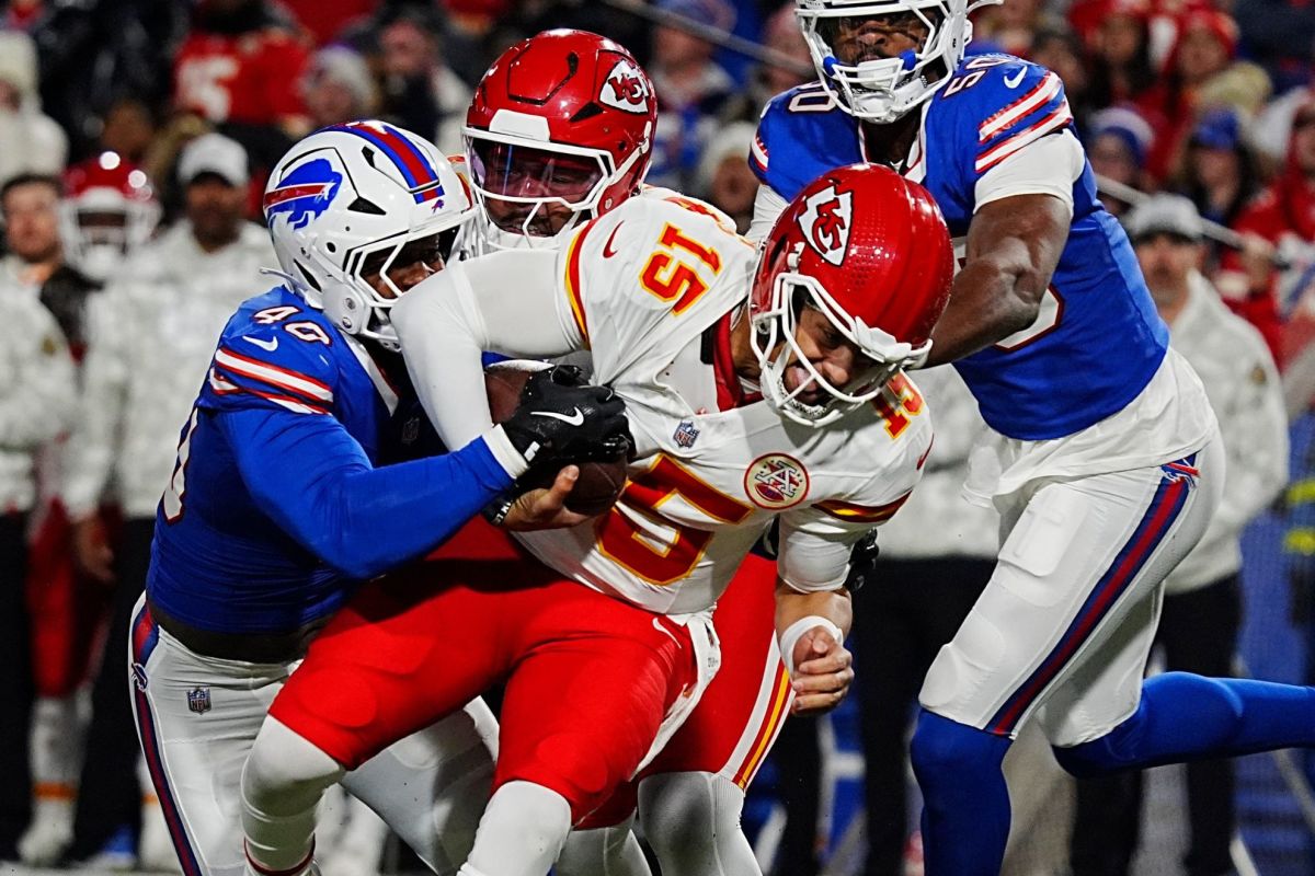 Buffalo Bills players Von Miller and Greg Rousseau sack Kansas City quarterback Patrick Mahomes (15).