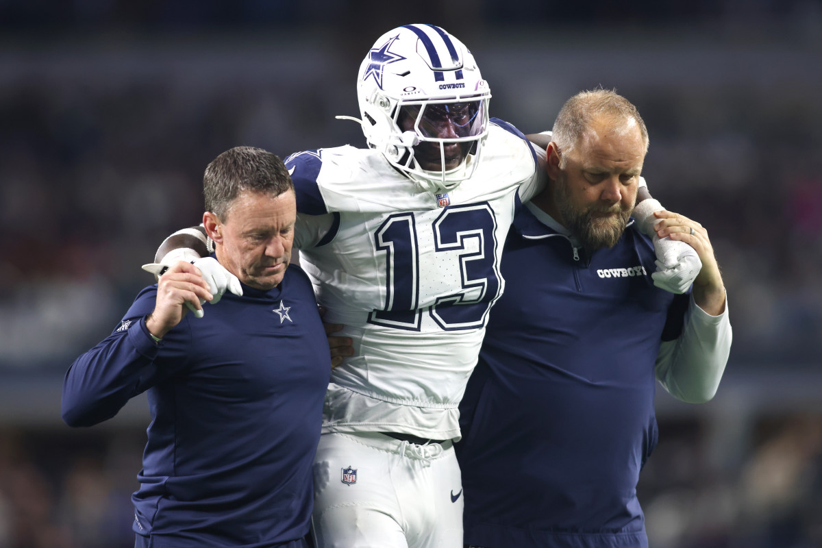 Dallas Cowboys linebacker DeMarvion Overshown is helped off the field after an injury against the Cincinnati Bengals.