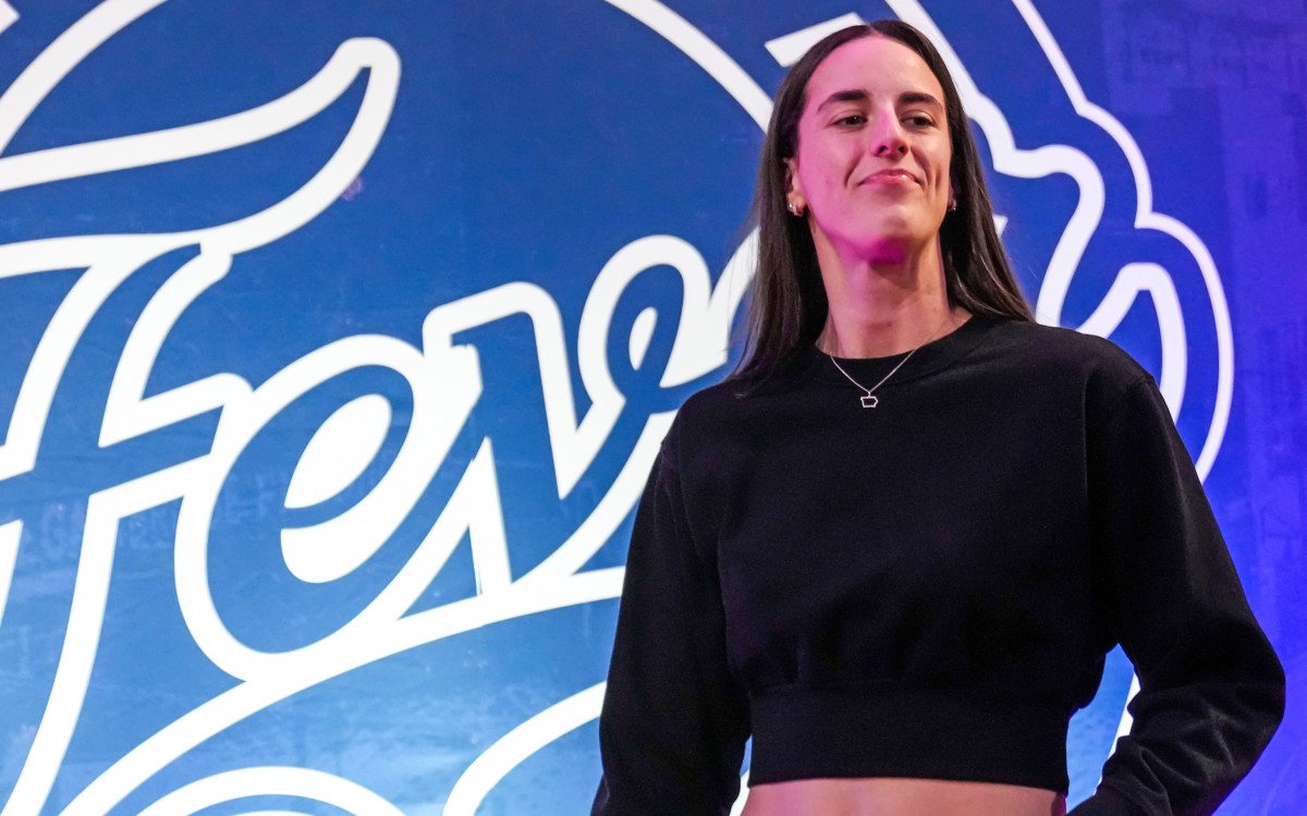 Indiana Fever guard Caitlin Clark (22) walks past the photo backdrop Wednesday, Aug. 28, 2024.