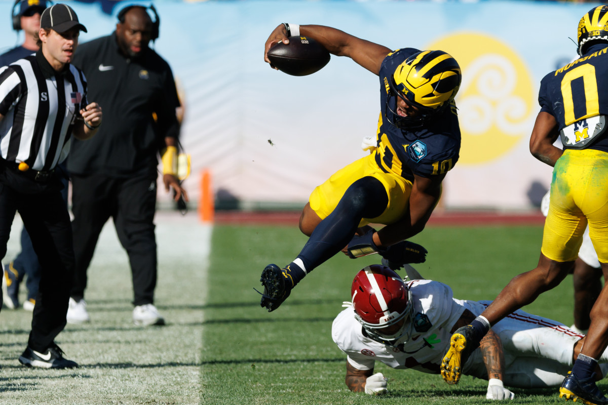 Alabama cornerback Domani Jackson tackles Alex Orji of Michigan at the ReliaQuest Bowl.