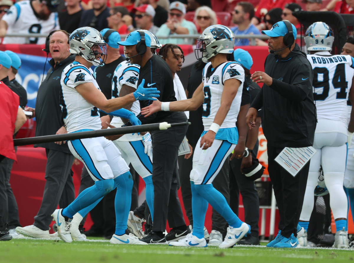 Carolina Panthers wide receiver Adam Thielen (19) is congratulated by quarterback Bryce Young (9) after he scored a touchdown against the Tampa Bay Buccaneersduring the second quarter at Raymond James Stadium.