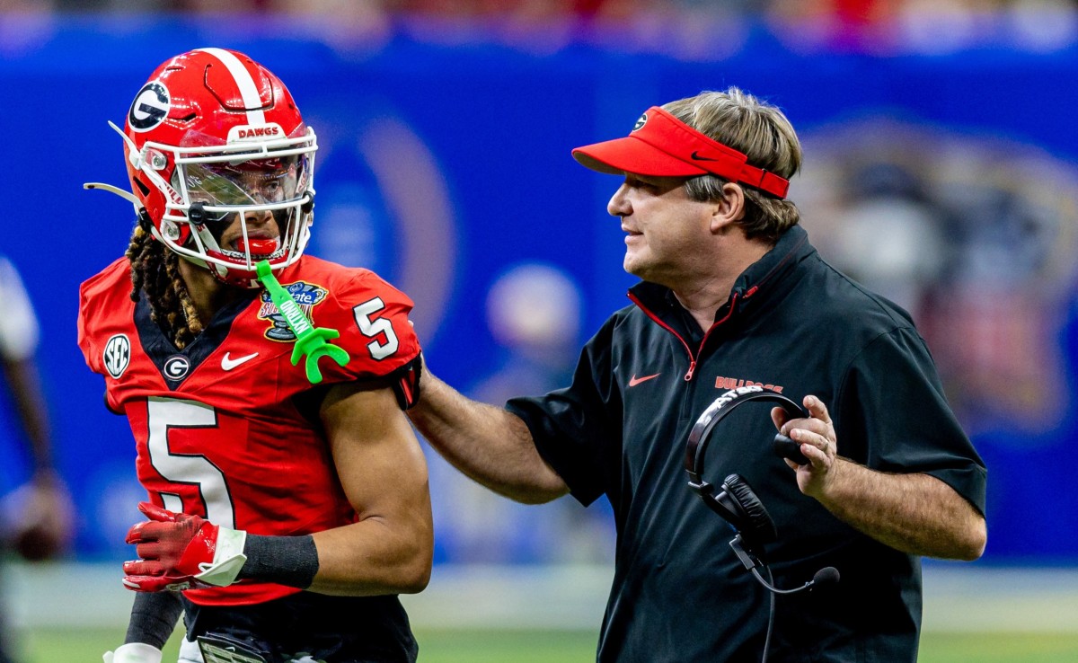 Jan 2, 2025; New Orleans, LA, USA; Georgia Bulldogs head coach Kirby Smart talks to wide receiver Anthony Evans III (5) before the kick off from the Notre Dame Fighting Irish during the first half at Caesars Superdome. Mandatory Credit: Stephen Lew-Imagn Images  