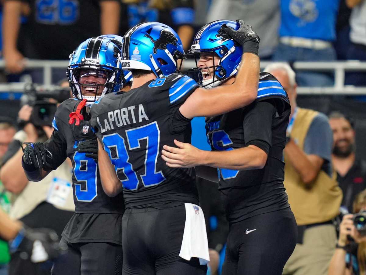 Detroit Lions quarterback Jared Goff (16) celebrates his touchdown with Detroit Lions tight end Sam LaPorta (87).