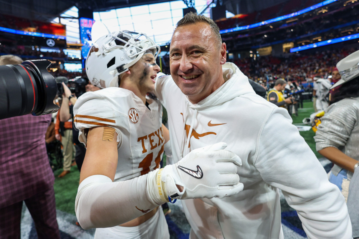 Jan 1, 2025; Atlanta, GA, USA; Texas Longhorns defensive back Michael Taaffe (16) and head coach Steve Sarkisian celebrate after a victory over the Arizona State Sun Devils in the Peach Bowl at Mercedes-Benz Stadium. Mandatory Credit: Brett Davis-Imagn Images  