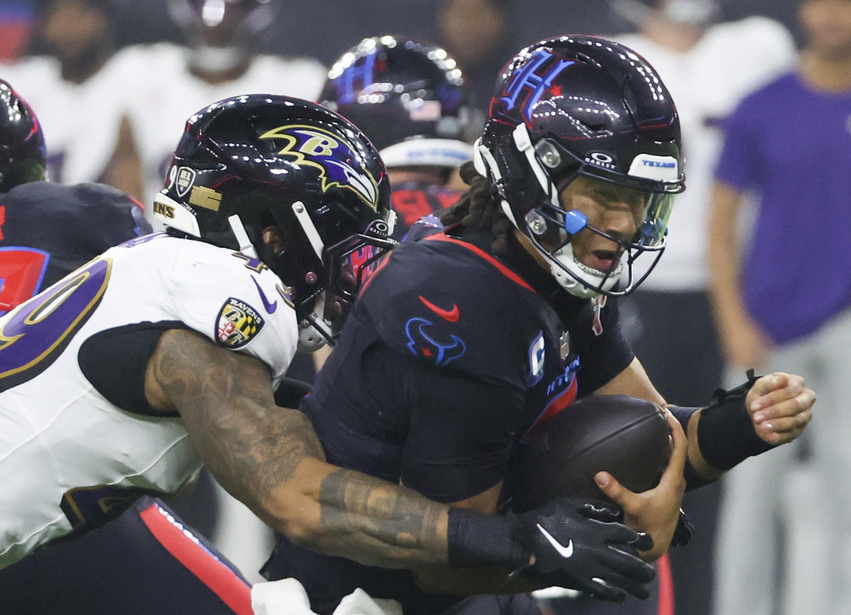 Dec 25, 2024; Houston, Texas, USA;Houston Texans quarterback C.J. Stroud (7) is sacked by Baltimore Ravens linebacker Chris Board (49) in the second half at NRG Stadium. Mandatory Credit: Thomas Shea-Imagn Images