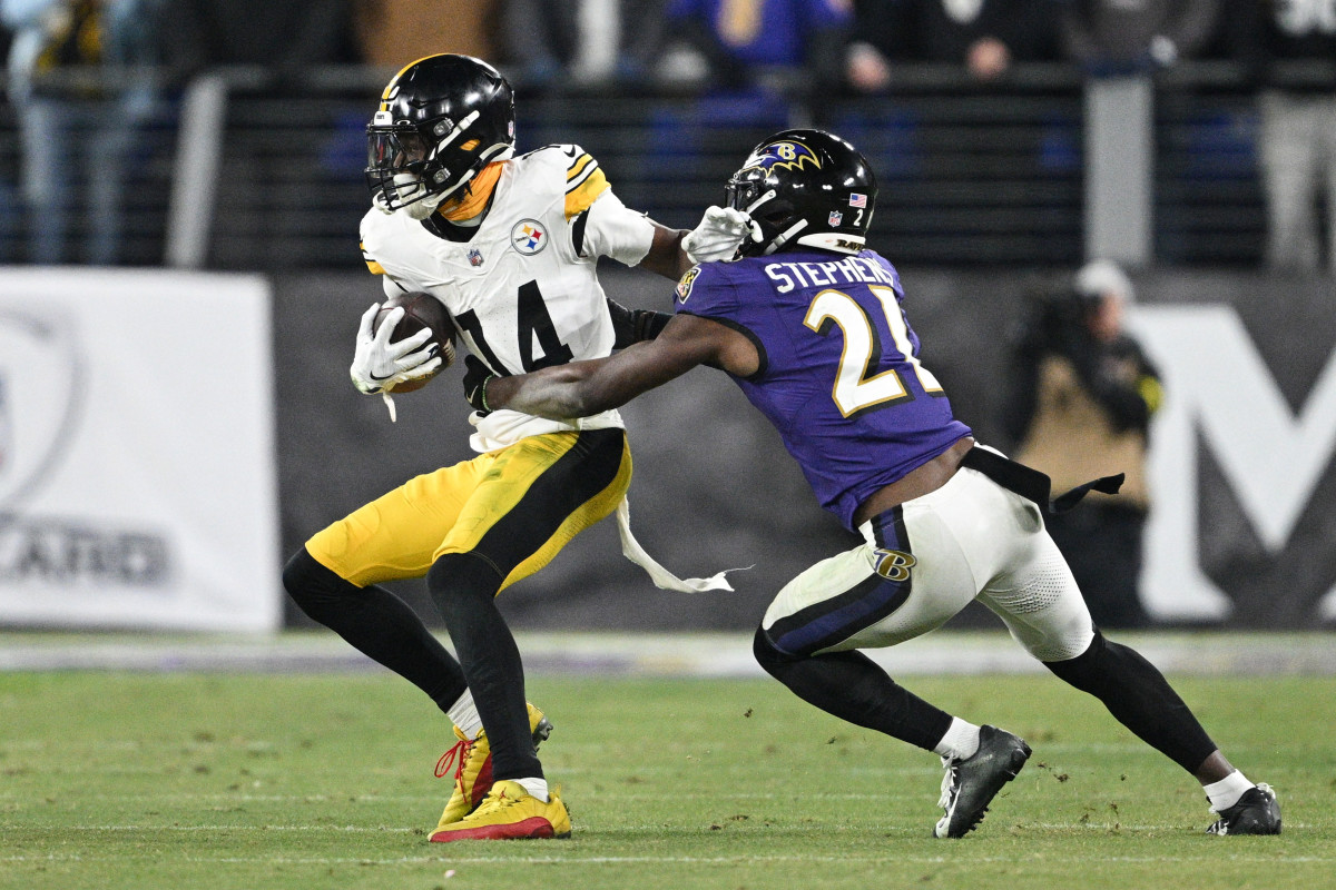 Jan 11, 2025; Baltimore, Maryland, USA; Pittsburgh Steelers wide receiver George Pickens (14) runs against Baltimore Ravens cornerback Brandon Stephens (21) in the fourth quarter in an AFC Wild Card game at M&T Bank Stadium.