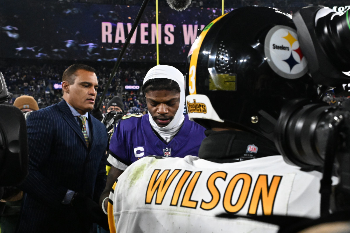 Baltimore Ravens QB Lamar Jackson meets with Pittsburgh Steelers QB Russell Wilson after beating Pittsburgh 28-14 in the wild-card round of the playoffs.