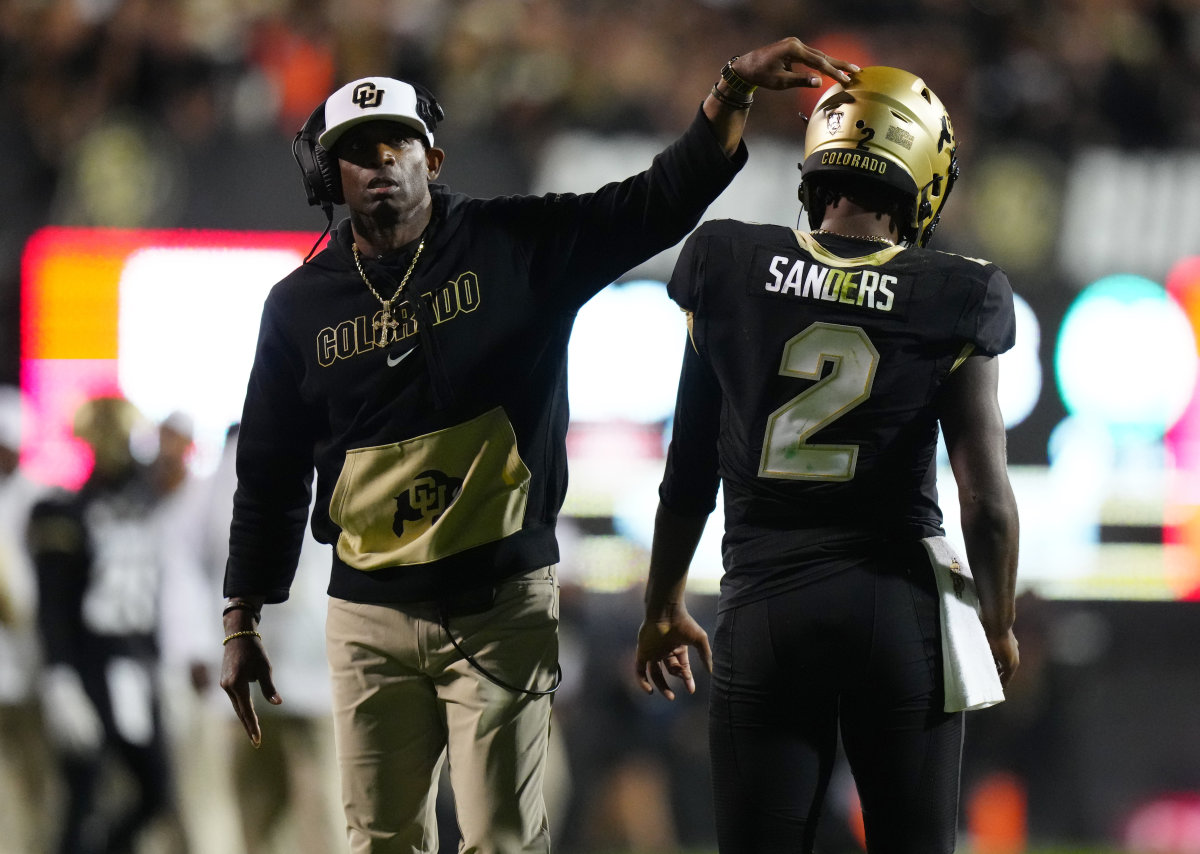 Colorado Buffaloes head coach Deion Sanders and quarterback Shedeur Sanders during a game against the Colorado State Rams.