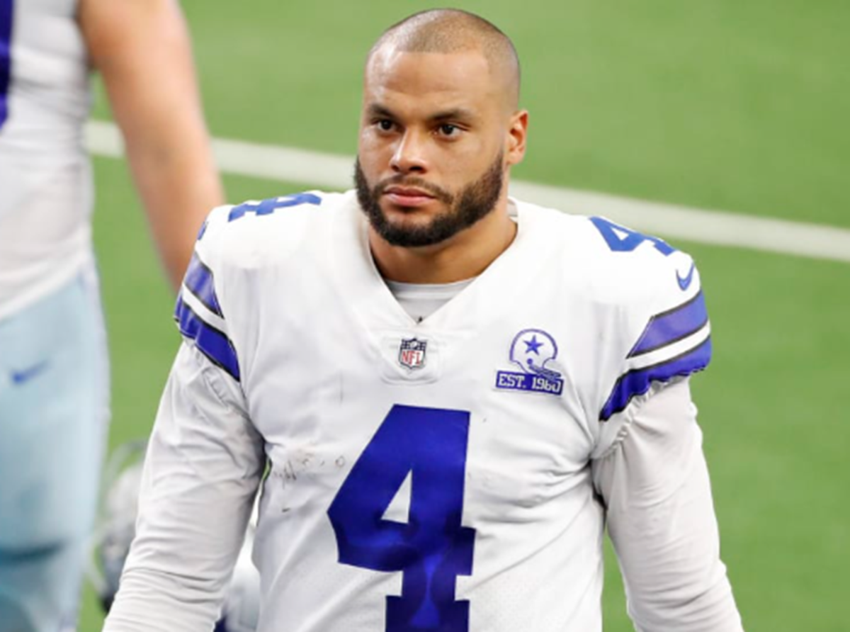 Dak Prescott walks off the field in a Cowboys uniform.