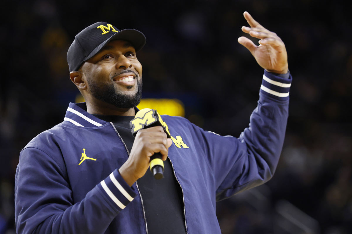 Sherrone Moore speaks at the Michigan vs. Northwestern basketball game on January 19.