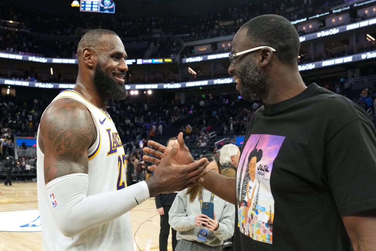 Los Angeles Lakers star LeBron James, left, shakes hands with Golden State's Draymond Green.