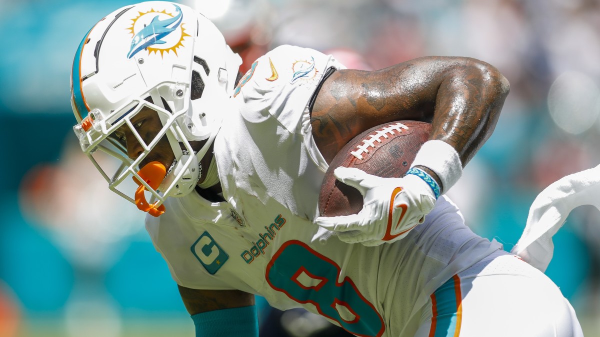 Miami Dolphins safety Jevon Holland (8) runs with the football after an interception during the first quarter against the New England Patriots.