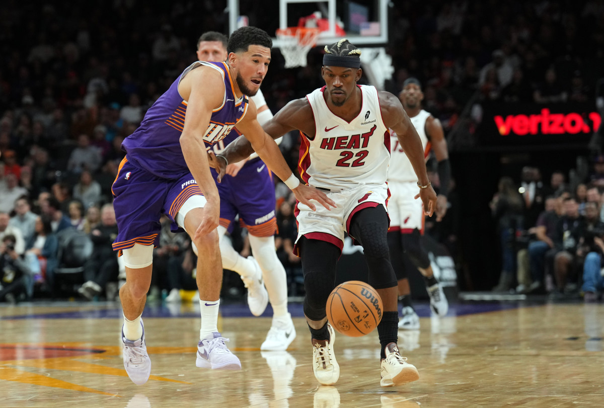 Miami Heat forward Jimmy Butler defends Phoenix Suns guard Devin Booker.