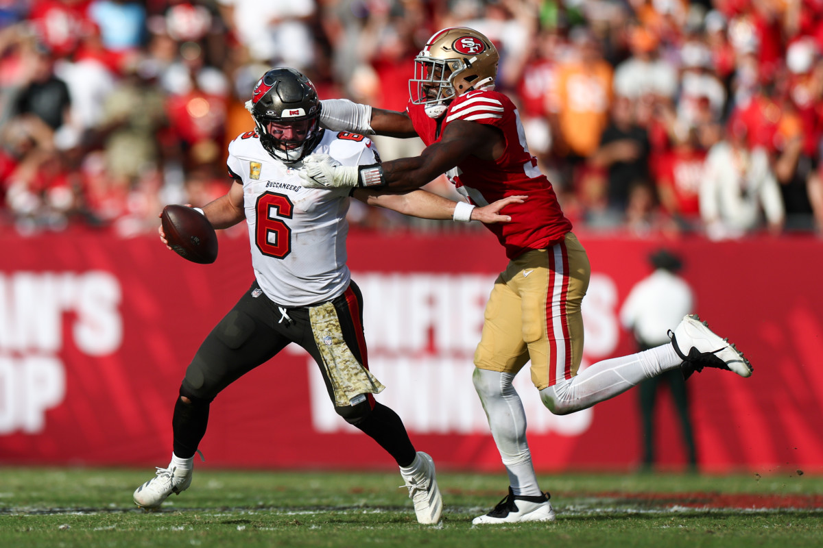 Nov 10, 2024; Tampa, Florida, USA; Tampa Bay Buccaneers quarterback Baker Mayfield (6) is pressured by San Francisco 49ers defensive end Leonard Floyd (56) in the fourth quarter at Raymond James Stadium.