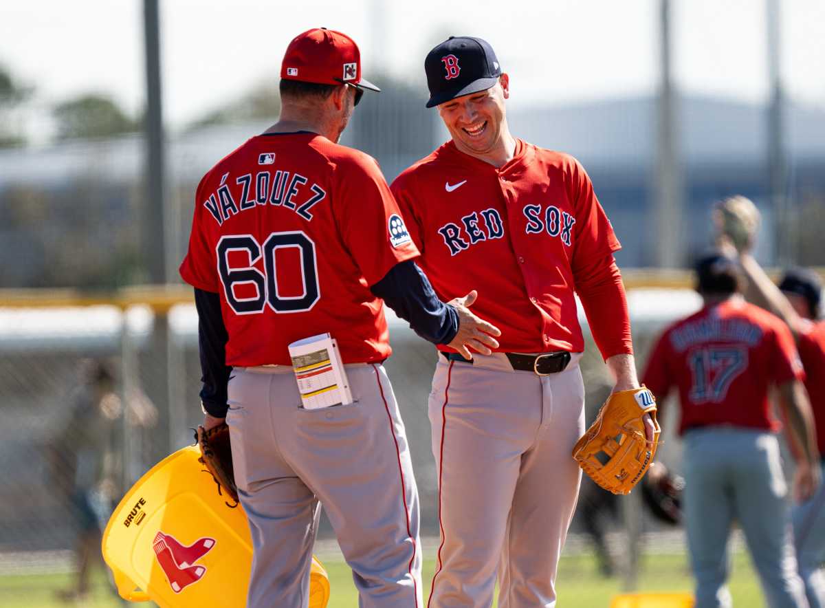 Alex Bregman of the Boston Red Sox has laugh with bench coach Ramón Vázquez during drills at JetBlue Park at Fenway South on Monday, Feb. 17, 2025.