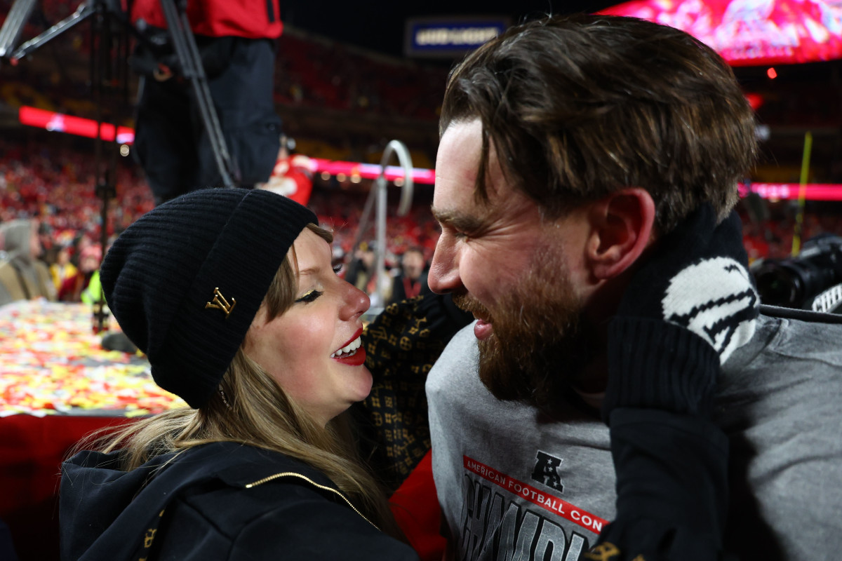 Recording artist Taylor Swift and Kansas City Chiefs tight end Travis Kelce (87) react after the AFC Championship game against the Buffalo Bills at GEHA Field at Arrowhead Stadium.