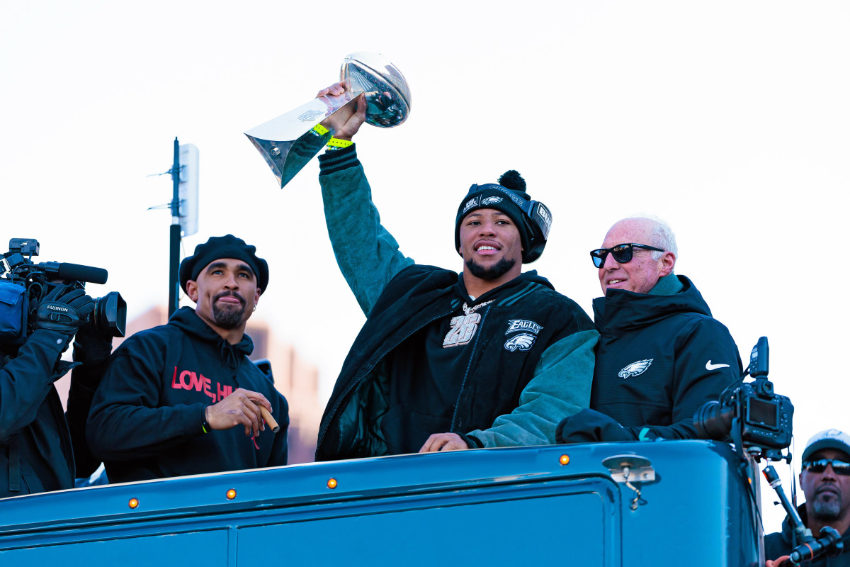 Philadelphia Eagles running back Saquon Barkley (26) lifts the Lombardi Trophy during the Super Bowl LIX championship parade.