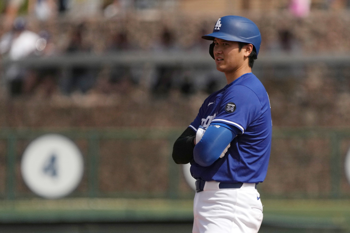 Dodgers star Shohei Ohtani (17) stands on second base against the  Guardians.