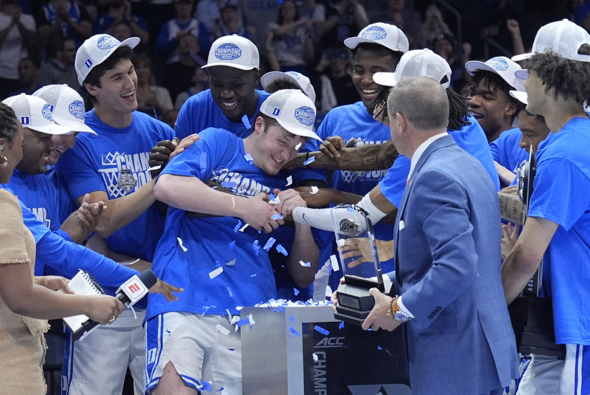 Duke Blue Devils guard Kon Knueppel (7) celebrates with teammates after winning the 2025 ACC Conference Tournament most valuable player award.